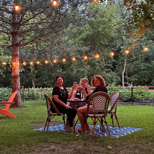 Friend enjoying wine among the dahlia field